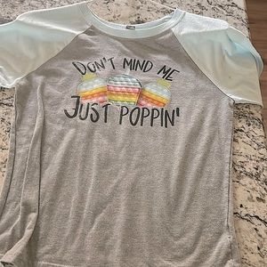 It is a medium size shirt,light blue sleeves,and pop it’s on the front